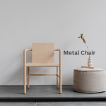 Metal chair against a wall a small round table by the chair.