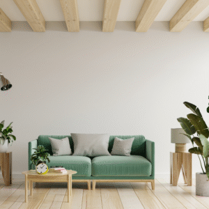 A living room with a green sofa, small coffee table and floor plants.