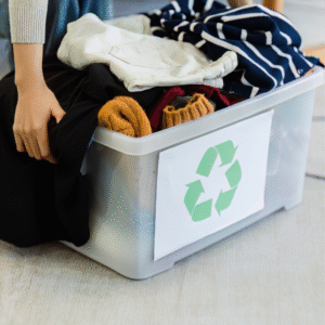 A plastic bin full of recycle clothes.