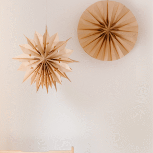 A brown paper star like hanging wall art.