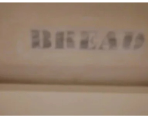 Printed bread label decoupaged to inside of bread box.