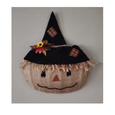 Scarecrow wreath hung on wall.