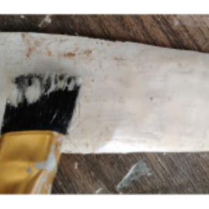 Adding glue to the back of the faux brick.