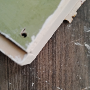 Small hole drilled in wood.
