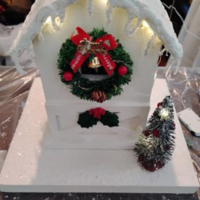 White birdhouse with Christmas decoration.