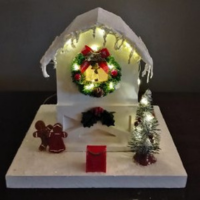 White birdhouse with Christmas decoration.