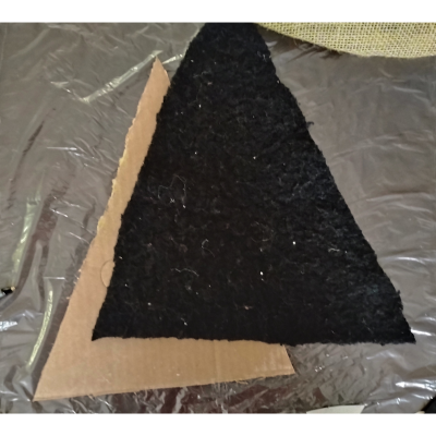 Cut fabric and cardboard triangle shape.