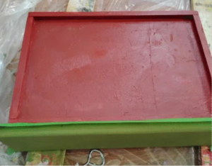 The inside of the drawer painted maroon.