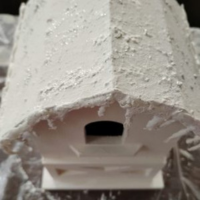 White birdhouse with snow on roof