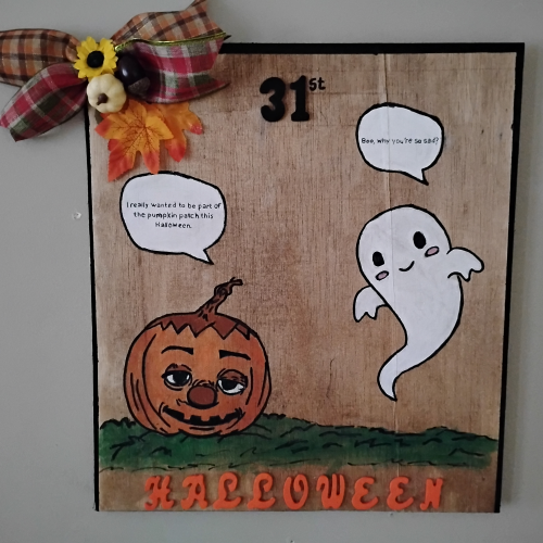Wall art of the ghost and pumpkin.