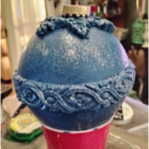 Blue ornament on a red plastic cup