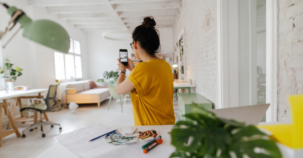 Woman taking pictures of her room.